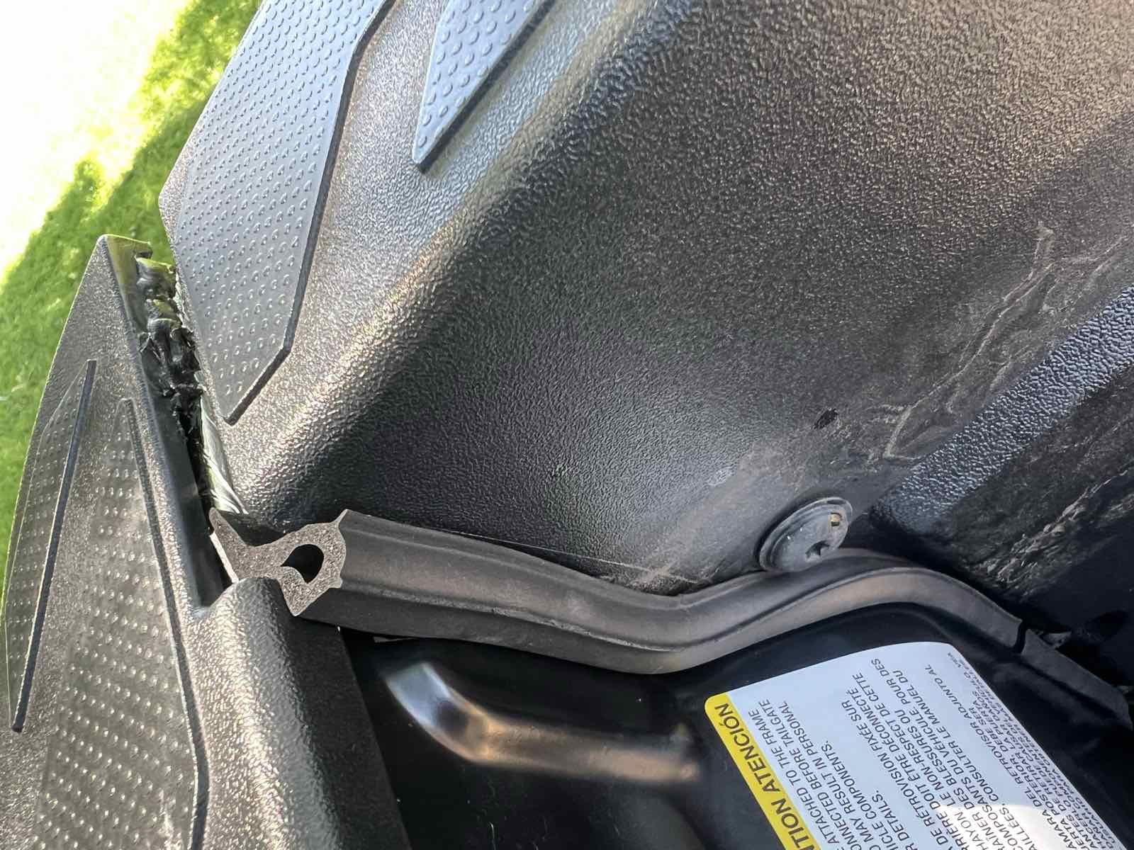 Interior view of a closed Tacoma tailgate with both the ROK Block and the sidewall taper seals installed, showing the corner now sealed.